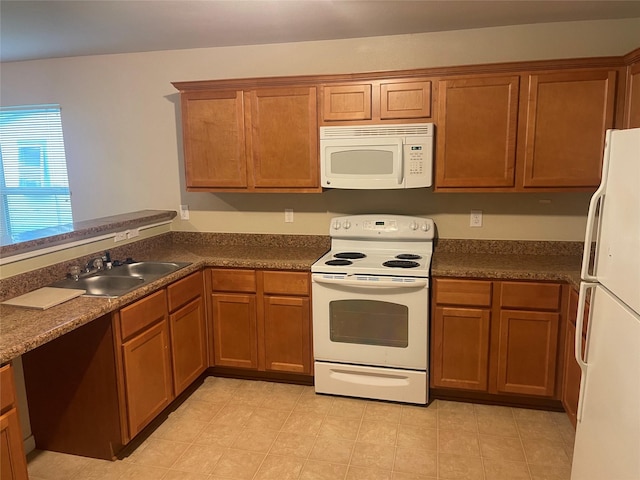 2430 Florence St, La Marque, TX 77568 - kitchen featuring white appliances, a sink, brown cabinets, and dark countertops