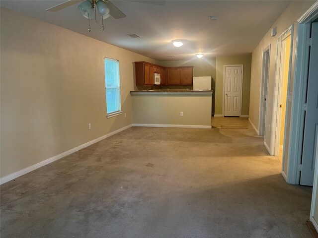 2430 Florence St, La Marque, TX 77568 - unfurnished living room featuring a ceiling fan, light colored carpet, and baseboards
