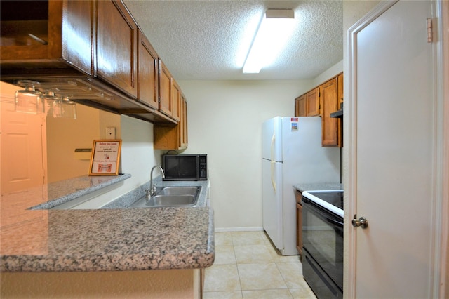 2121 Hepburn Sts Unit 713, Houston, TX 77054 - kitchen featuring black appliances, a sink, brown cabinetry, a textured ceiling, and light countertops