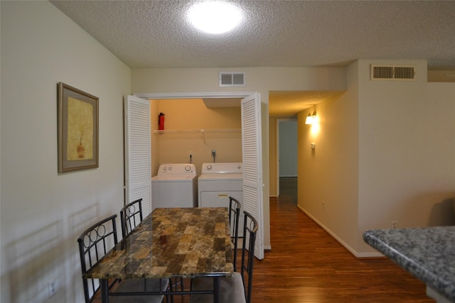 2121 Hepburn Sts Unit 713, Houston, TX 77054 - dining room with separate washer and dryer, dark wood-type flooring, a textured ceiling, and baseboards