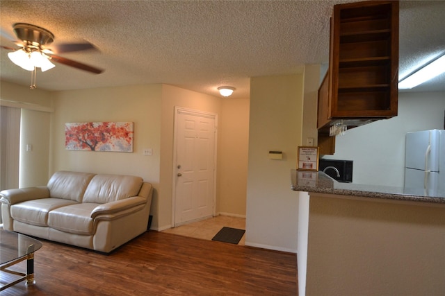 2121 Hepburn Sts Unit 713, Houston, TX 77054 - living area with a ceiling fan, wood finished floors, and a textured ceiling