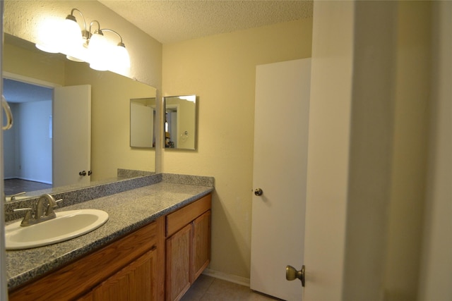 2121 Hepburn Sts Unit 713, Houston, TX 77054 - bathroom featuring a textured ceiling, vanity, and tile patterned flooring