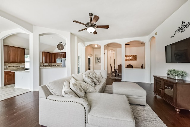 7518 Rain Meadow Ln, Cypress, TX 77433 - living area featuring ceiling fan, arched walkways, and dark wood-style floors