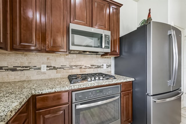 7518 Rain Meadow Ln, Cypress, TX 77433 - kitchen with appliances with stainless steel finishes, backsplash, and light stone countertops
