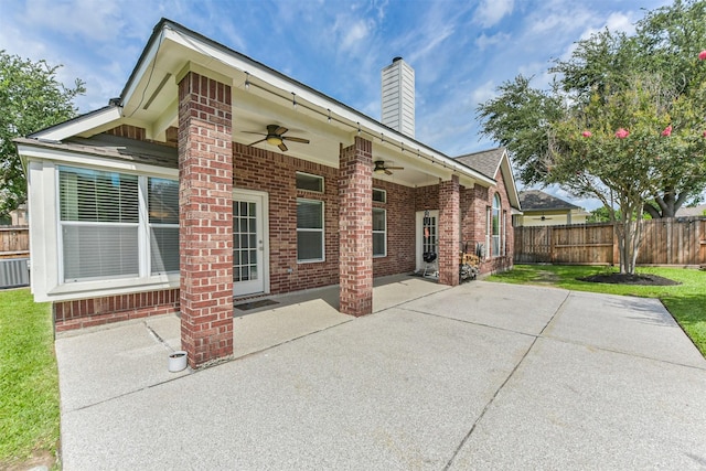 7518 Rain Meadow Ln, Cypress, TX 77433 - back of property with a ceiling fan, brick siding, a patio, and a chimney