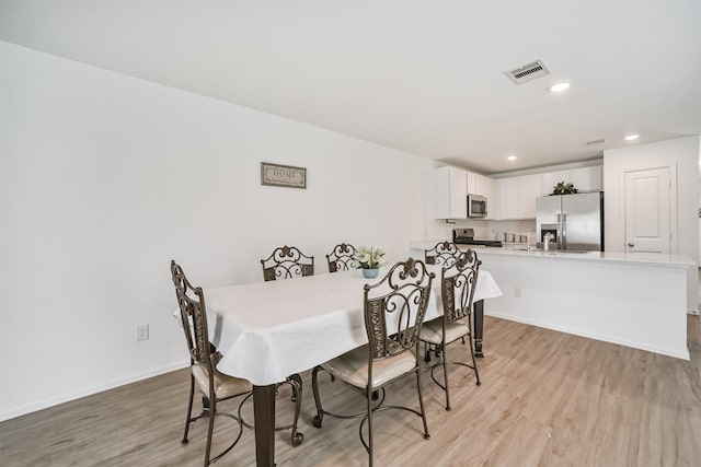 337 Riverwood Village Ln, Sealy, TX 77474 - dining room featuring light wood-style floors, recessed lighting, and baseboards