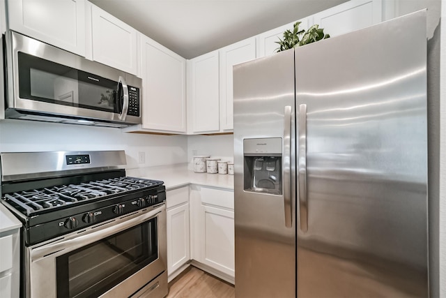 337 Riverwood Village Ln, Sealy, TX 77474 - kitchen featuring stainless steel appliances, light countertops, and white cabinetry