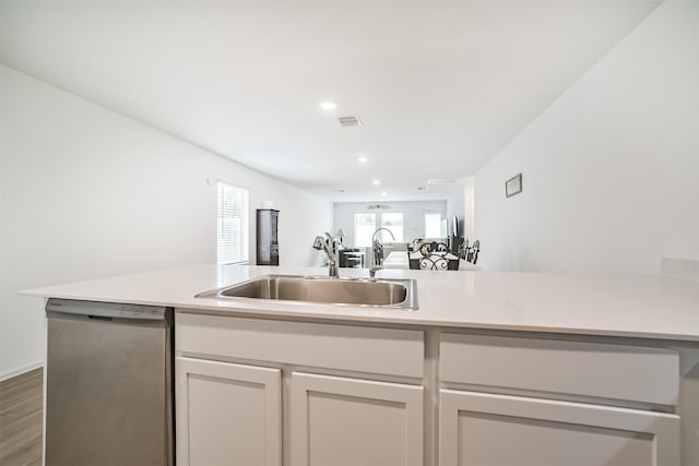 337 Riverwood Village Ln, Sealy, TX 77474 - kitchen with dishwasher, light countertops, a sink, wood finished floors, and open floor plan
