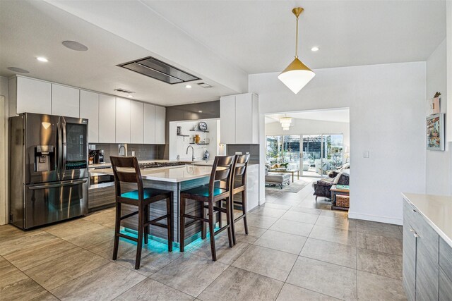 5231 Lamonte Ln, Houston, TX 77092 - kitchen featuring stainless steel refrigerator with ice dispenser, light countertops, white cabinets, a sink, and recessed lighting