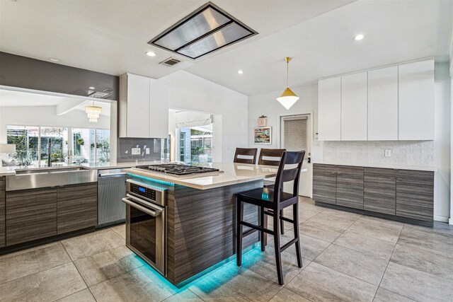 5231 Lamonte Ln, Houston, TX 77092 - kitchen featuring stainless steel appliances, white cabinets, modern cabinets, light countertops, and recessed lighting