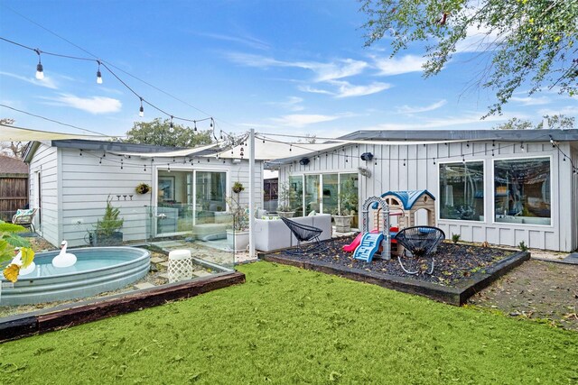 5231 Lamonte Ln, Houston, TX 77092 - back of property with a lawn, board and batten siding, and an outdoor structure