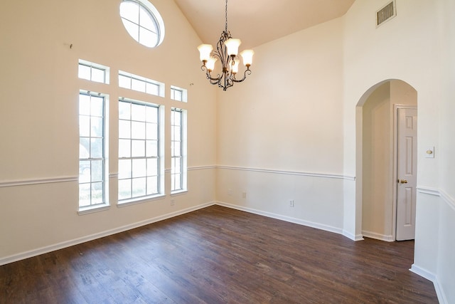 3550 Beacons Vw, Friendswood, TX 77546 - empty room with dark wood-style floors, arched walkways, baseboards, a chandelier, and high vaulted ceiling