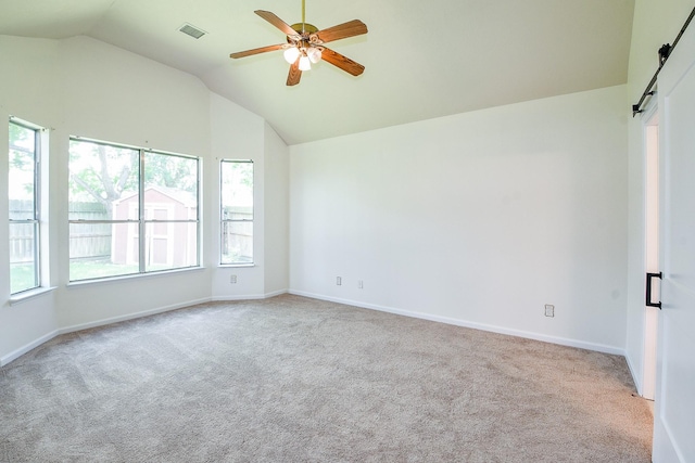 3550 Beacons Vw, Friendswood, TX 77546 - carpeted empty room with a barn door, vaulted ceiling, plenty of natural light, a ceiling fan, and baseboards