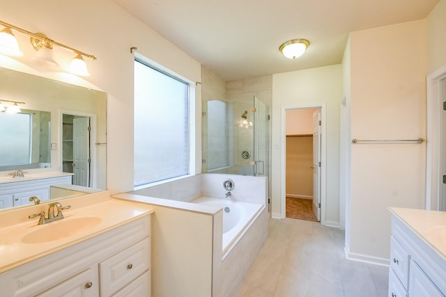 3550 Beacons Vw, Friendswood, TX 77546 - bathroom with vanity, a stall shower, a spacious closet, a garden tub, and tile patterned flooring