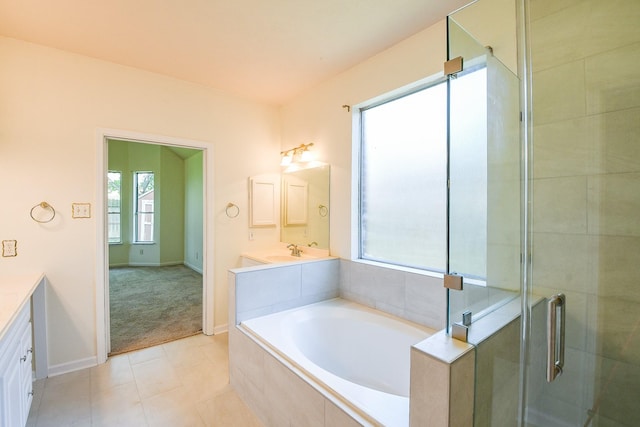 3550 Beacons Vw, Friendswood, TX 77546 - full bathroom featuring vanity, a garden tub, a shower stall, baseboards, and tile patterned flooring