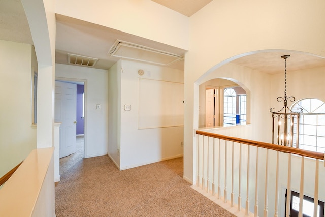 3550 Beacons Vw, Friendswood, TX 77546 - hallway with attic access, carpet floors, a chandelier, and arched walkways