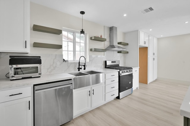 6026 Willowbend Blvd, Houston, TX 77096 - kitchen with stainless steel appliances, open shelves, wall chimney exhaust hood, a sink, and white cabinets