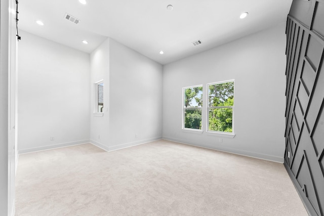 4710 Gunter St, Houston, TX 77020 - empty room featuring light colored carpet, recessed lighting, and baseboards