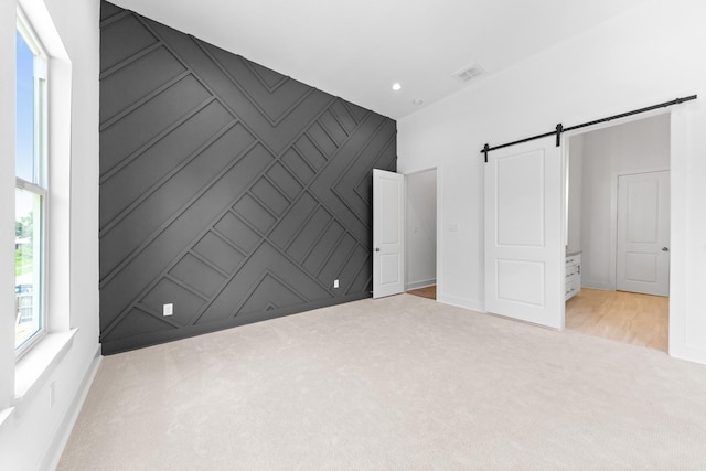 4710 Gunter St, Houston, TX 77020 - unfurnished bedroom featuring a barn door, carpet flooring, baseboards, and recessed lighting