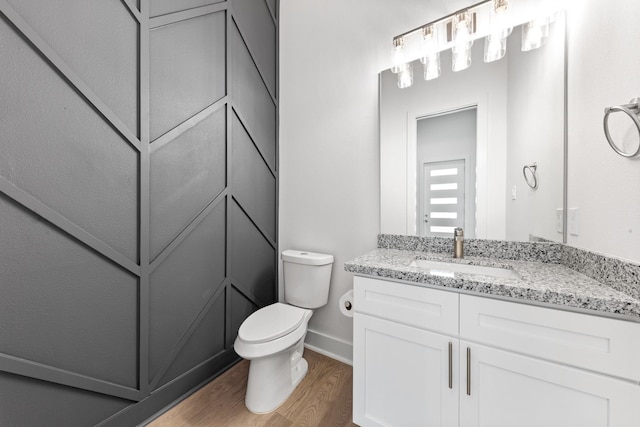 4710 Gunter St, Houston, TX 77020 - bathroom featuring wood finished floors, vanity, toilet, and baseboards