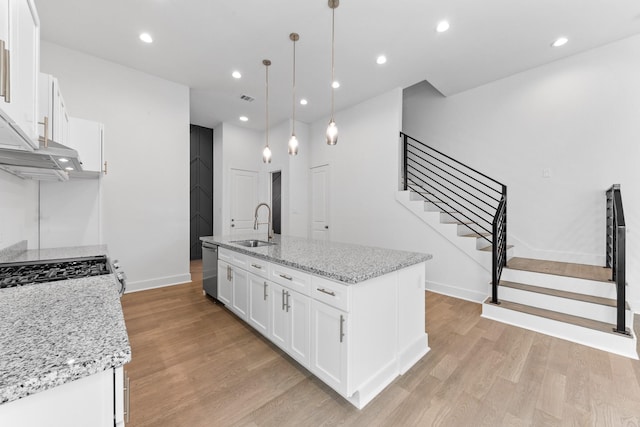 4710 Gunter St, Houston, TX 77020 - kitchen featuring baseboards, light wood-style flooring, white cabinets, dishwasher, and recessed lighting