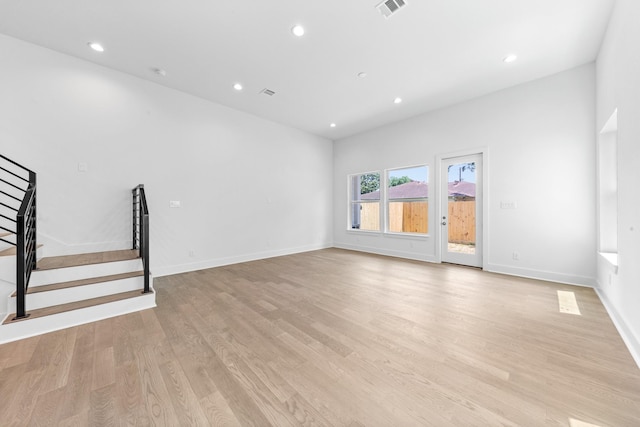 4710 Gunter St, Houston, TX 77020 - spare room with stairs, light wood-style floors, recessed lighting, and baseboards