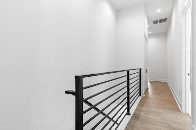 4710 Gunter St, Houston, TX 77020 - corridor with an upstairs landing, light wood-type flooring, recessed lighting, and baseboards