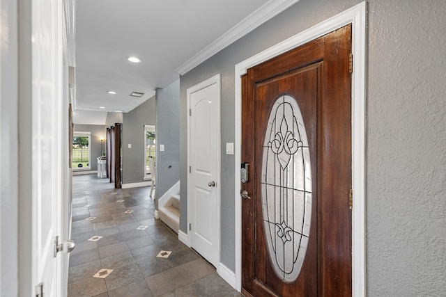 20107 Sunny Shores Dr, Humble, TX 77346 - entryway with a textured wall, recessed lighting, baseboards, dark tile patterned floors, and ornamental molding