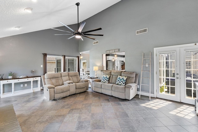 20107 Sunny Shores Dr, Humble, TX 77346 - living room with french doors, high vaulted ceiling, ceiling fan, baseboards, and plenty of natural light