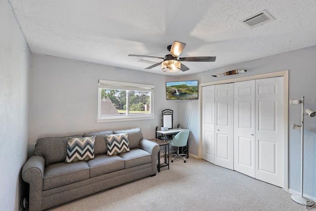 20107 Sunny Shores Dr, Humble, TX 77346 - carpeted living room featuring ceiling fan, a textured ceiling, and baseboards