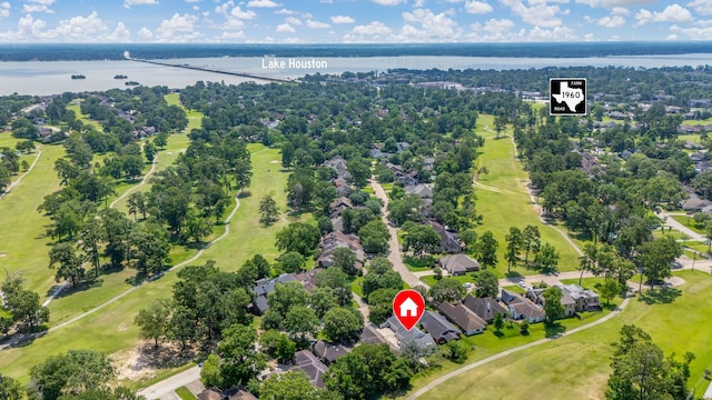 20107 Sunny Shores Dr, Humble, TX 77346 - aerial perspective of suburban area with a nearby body of water, a tree filled landscape, and a notable bridge