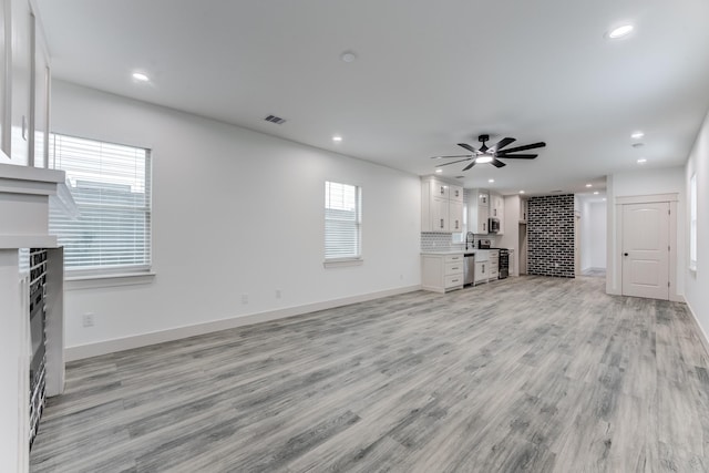 337 Todd St, Tomball, TX 77375 - unfurnished living room featuring recessed lighting, light wood-type flooring, ceiling fan, a fireplace, and baseboards