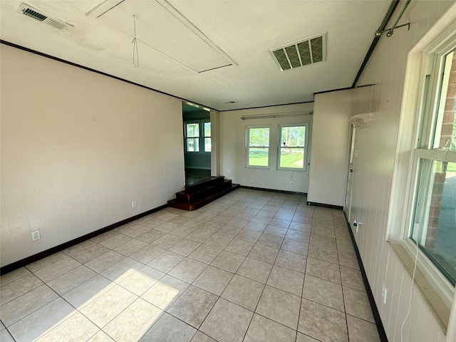 3918 County Road 507, Brazoria, TX 77422 - empty room with attic access, light tile patterned flooring, and baseboards