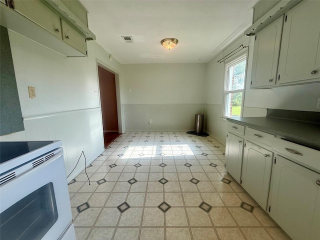 3918 County Road 507, Brazoria, TX 77422 - kitchen featuring light flooring, white range with electric stovetop, and dark countertops