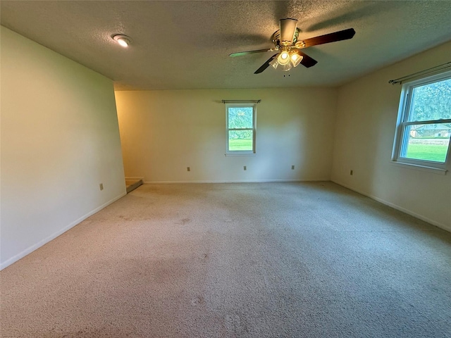 3918 County Road 507, Brazoria, TX 77422 - spare room with a textured ceiling, healthy amount of natural light, light colored carpet, baseboards, and ceiling fan
