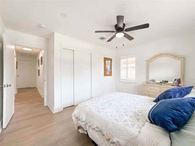 2302 Hewitt Dr, Houston, TX 77018 - bedroom with light wood-style flooring, a closet, attic access, ceiling fan, and baseboards