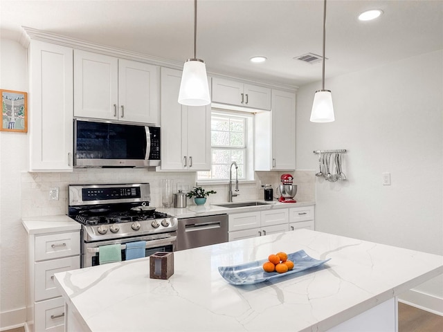2302 Hewitt Dr, Houston, TX 77018 - kitchen with appliances with stainless steel finishes, a sink, decorative backsplash, recessed lighting, and white cabinets