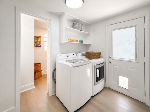 2302 Hewitt Dr, Houston, TX 77018 - washroom featuring washing machine and clothes dryer, light wood-style floors, and baseboards