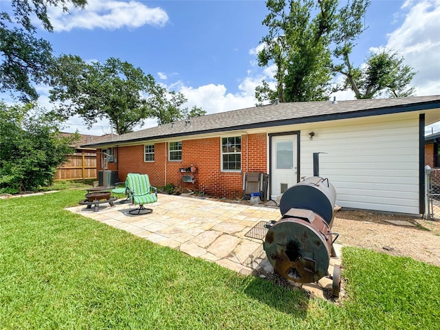 2302 Hewitt Dr, Houston, TX 77018 - back of property featuring a patio area, cooling unit, brick siding, and a fire pit
