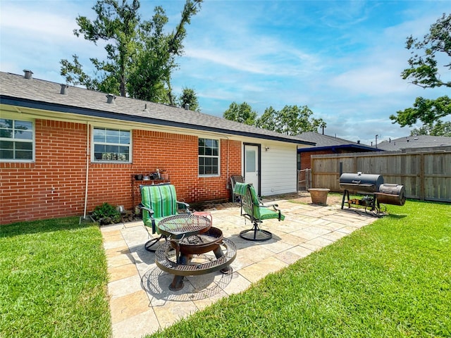 2302 Hewitt Dr, Houston, TX 77018 - back of property with an outdoor fire pit, brick siding, a patio area, and roof with shingles