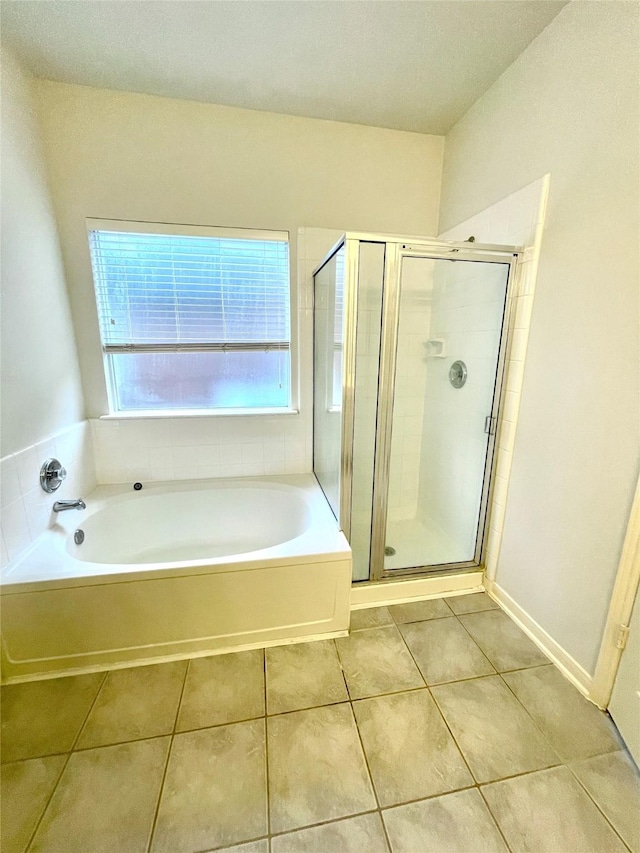 2534 Honeysuckle Walk, Spring, TX 77388 - bathroom featuring tile patterned floors, a bath, and a stall shower