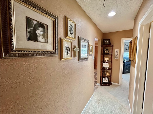 728 S Remington Dr, Angleton, TX 77515 - hallway featuring a textured wall, carpet, baseboards, and a textured ceiling