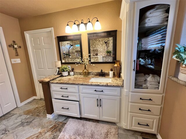 728 S Remington Dr, Angleton, TX 77515 - bathroom featuring vanity, marble finish flooring, and baseboards