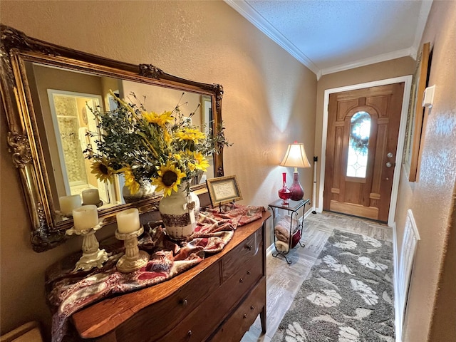 728 S Remington Dr, Angleton, TX 77515 - entrance foyer featuring a textured wall, crown molding, baseboards, and light wood-type flooring