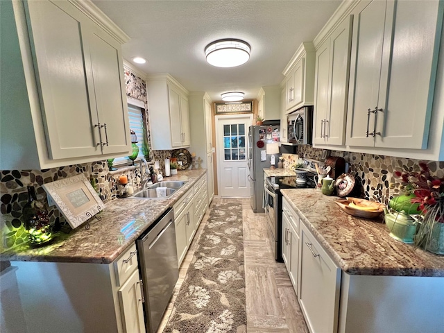728 S Remington Dr, Angleton, TX 77515 - kitchen featuring stainless steel appliances, a sink, decorative backsplash, and light stone countertops
