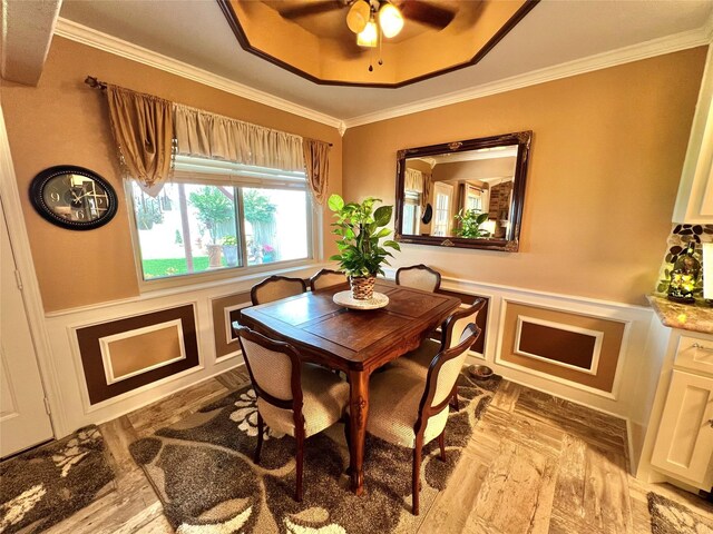 728 S Remington Dr, Angleton, TX 77515 - dining area with crown molding, a wainscoted wall, ceiling fan, a decorative wall, and a raised ceiling