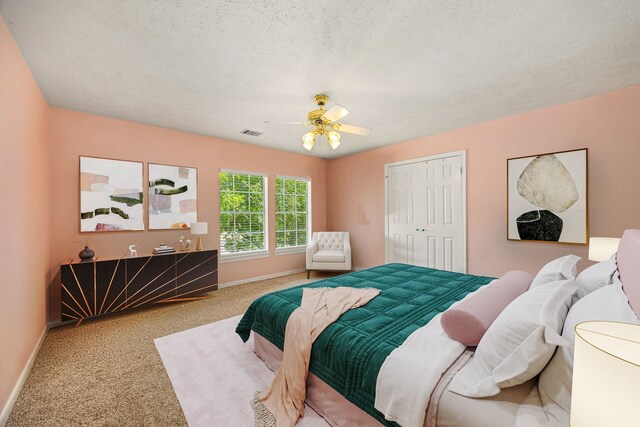 24714 Valleylight Dr, Katy, TX 77494 - carpeted bedroom with baseboards, a ceiling fan, a textured ceiling, and a closet