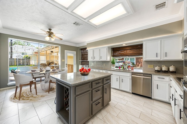 24714 Valleylight Dr, Katy, TX 77494 - kitchen with dishwasher, backsplash, white cabinetry, ornamental molding, and a textured ceiling