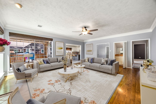 24714 Valleylight Dr, Katy, TX 77494 - living room featuring ceiling fan, wood finished floors, a textured ceiling, and ornamental molding