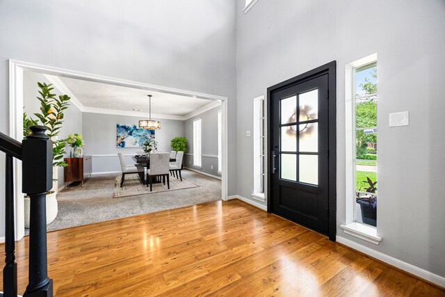 24714 Valleylight Dr, Katy, TX 77494 - foyer entrance with ornamental molding, wood finished floors, a chandelier, baseboards, and a towering ceiling